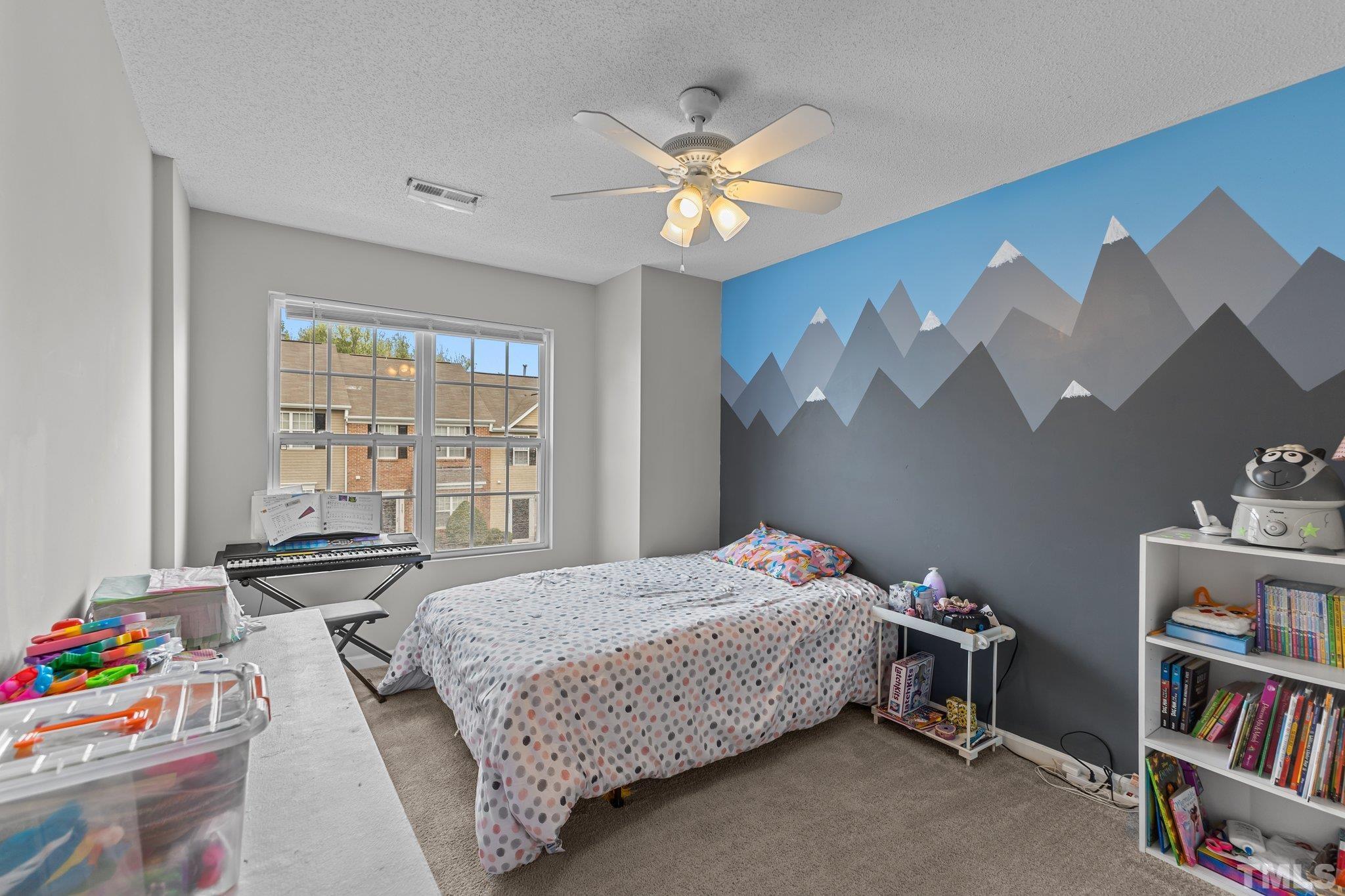 3366 Bridgeville Road Raleigh, NC 27610 - Photo 26 of 37 a bedroom with a bed furniture and a book shelf