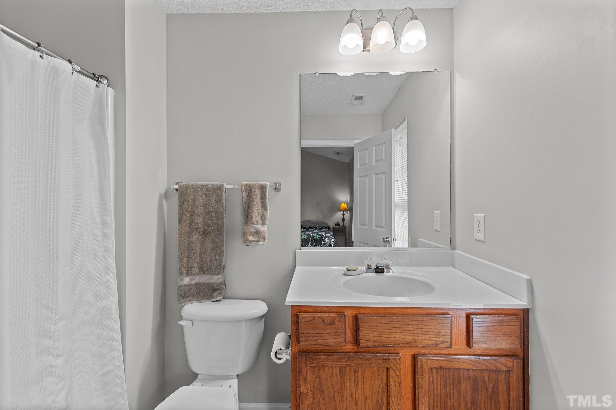3366 Bridgeville Road Raleigh, NC 27610 - Photo 27 of 37 a bathroom with a sink toilet and shower