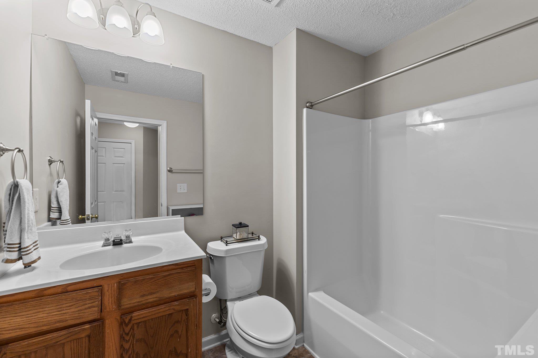 3366 Bridgeville Road Raleigh, NC 27610 - Photo 30 of 37 a bathroom with a sink toilet vanity and shower