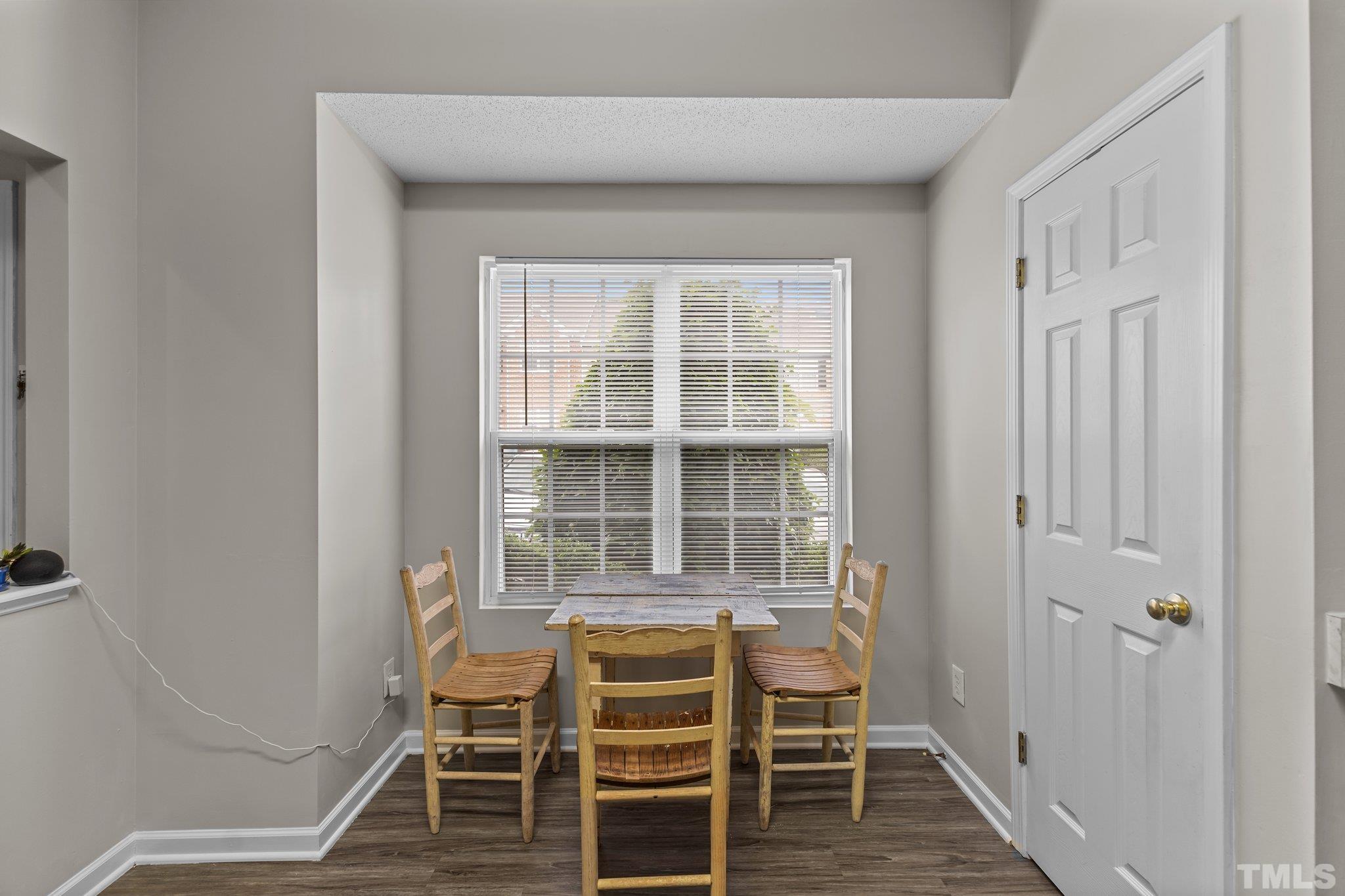 3366 Bridgeville Road Raleigh, NC 27610 - Photo 7 of 37 a view of a room with wooden floor and windows