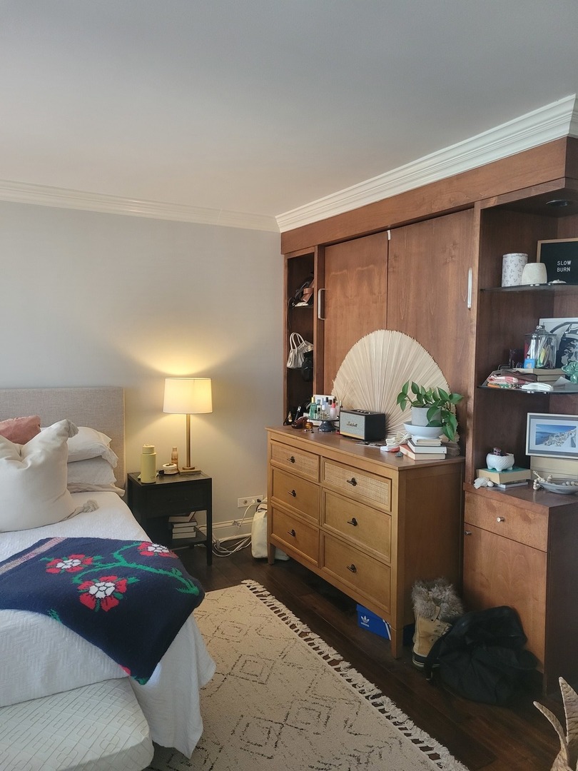 111 East Chestnut Street, Unit 20D Chicago, IL 60611 - Photo 4 of 8 a bedroom with a bed and a table