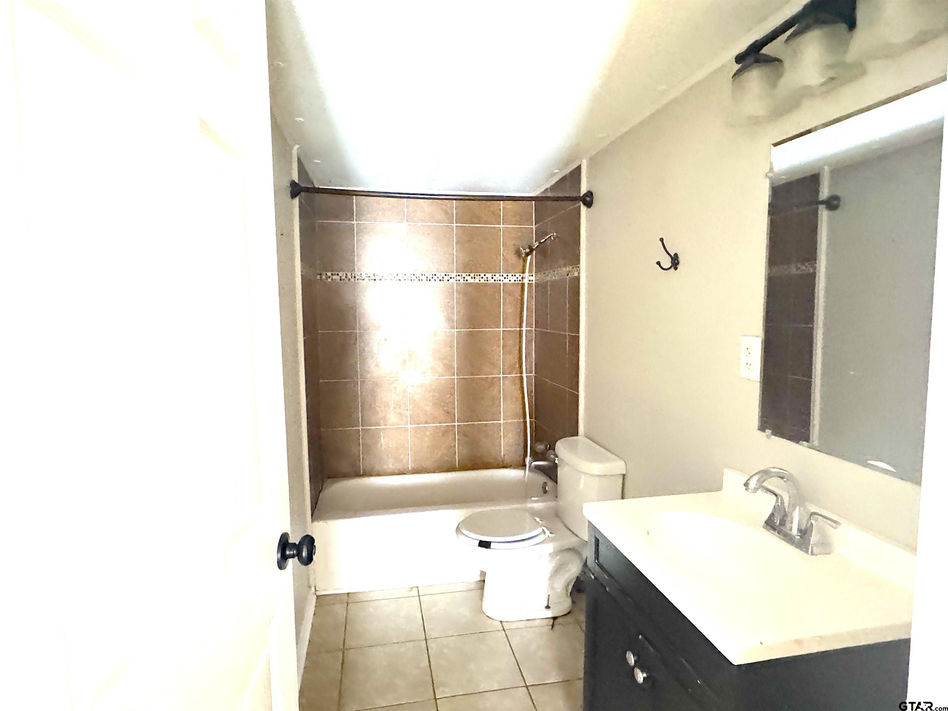 1391 San Saba Road Mount Vernon, TX 75457 - Photo 11 of 13 a bathroom with a sink vanity granite tub shower and a mirror