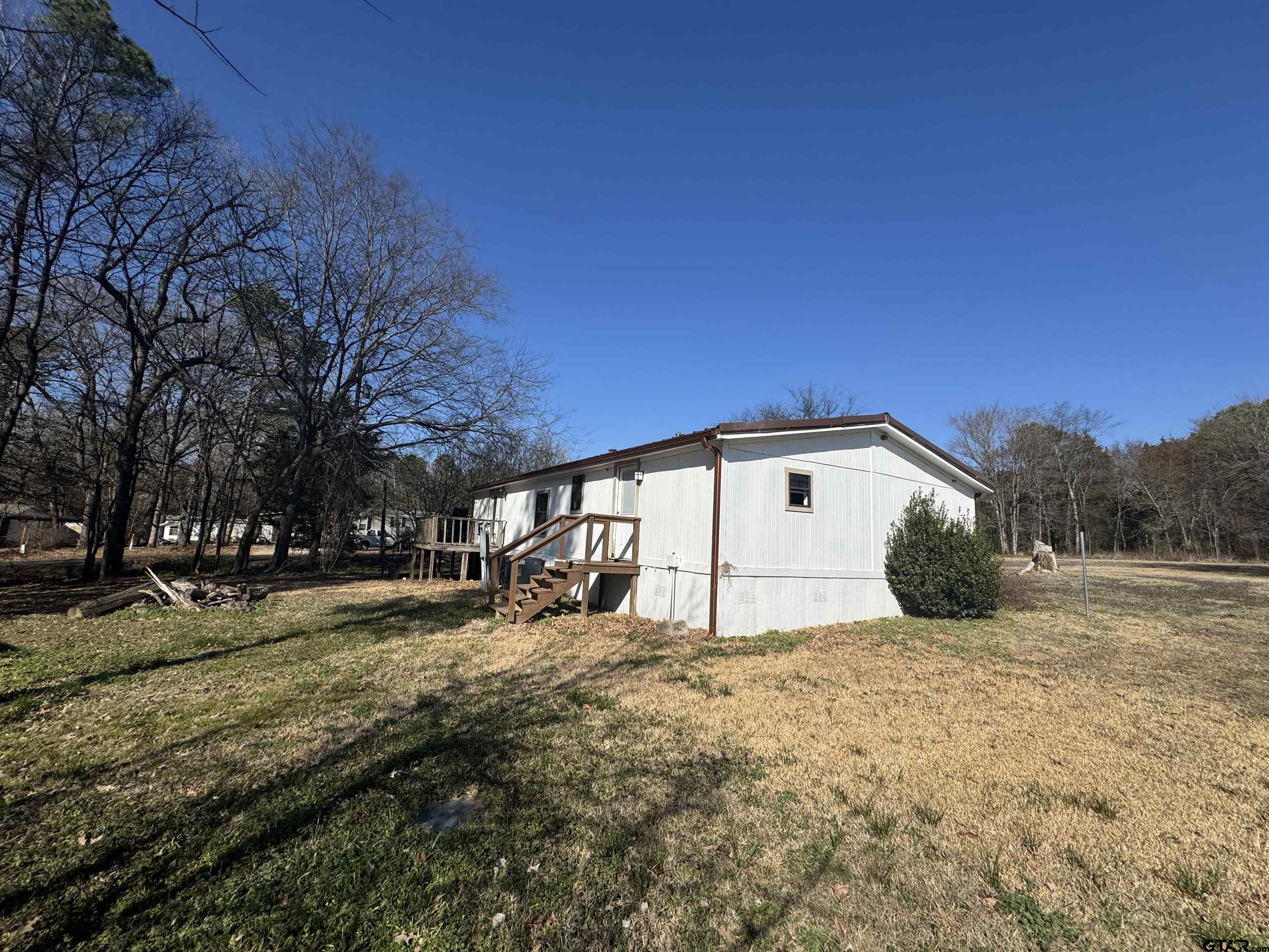 1391 San Saba Road Mount Vernon, TX 75457 - Photo 2 of 13 a view of backyard with large trees