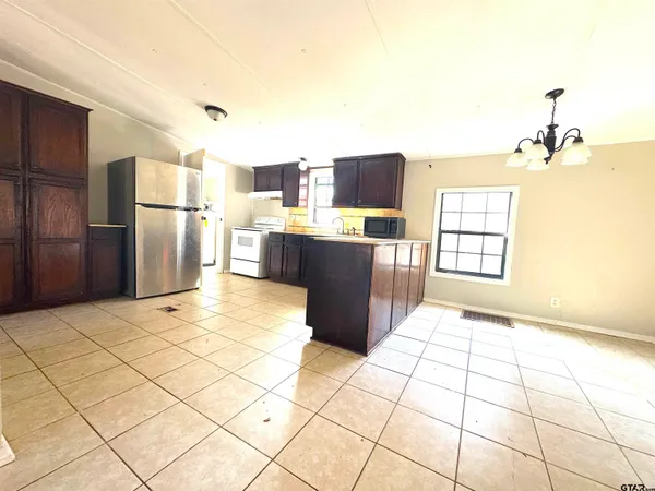 a kitchen with stainless steel appliances a refrigerator and a stove top oven