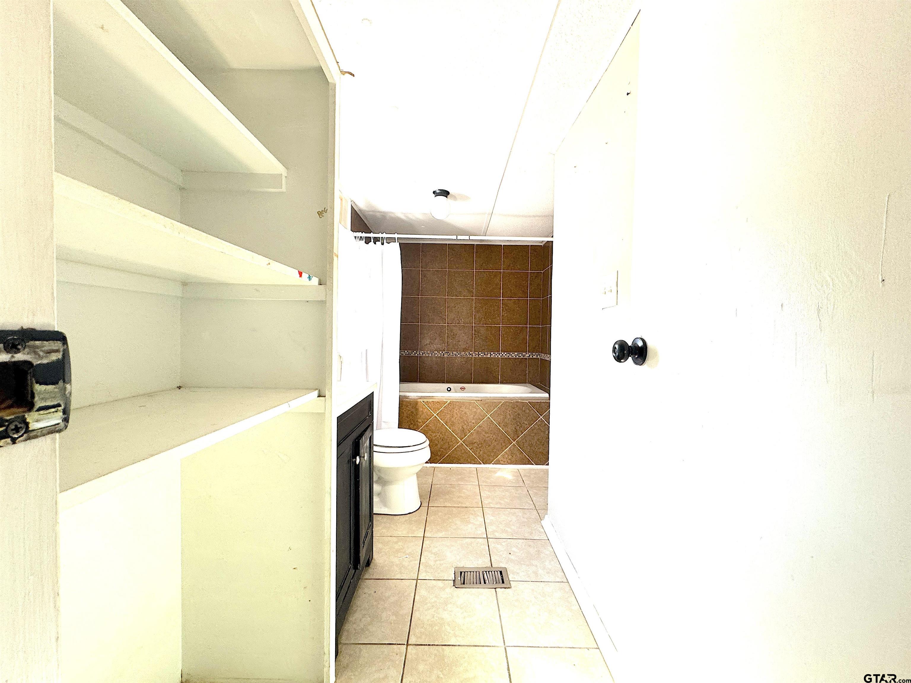 1391 San Saba Road Mount Vernon, TX 75457 - Photo 9 of 13 a bathroom with a bathtub and a shower