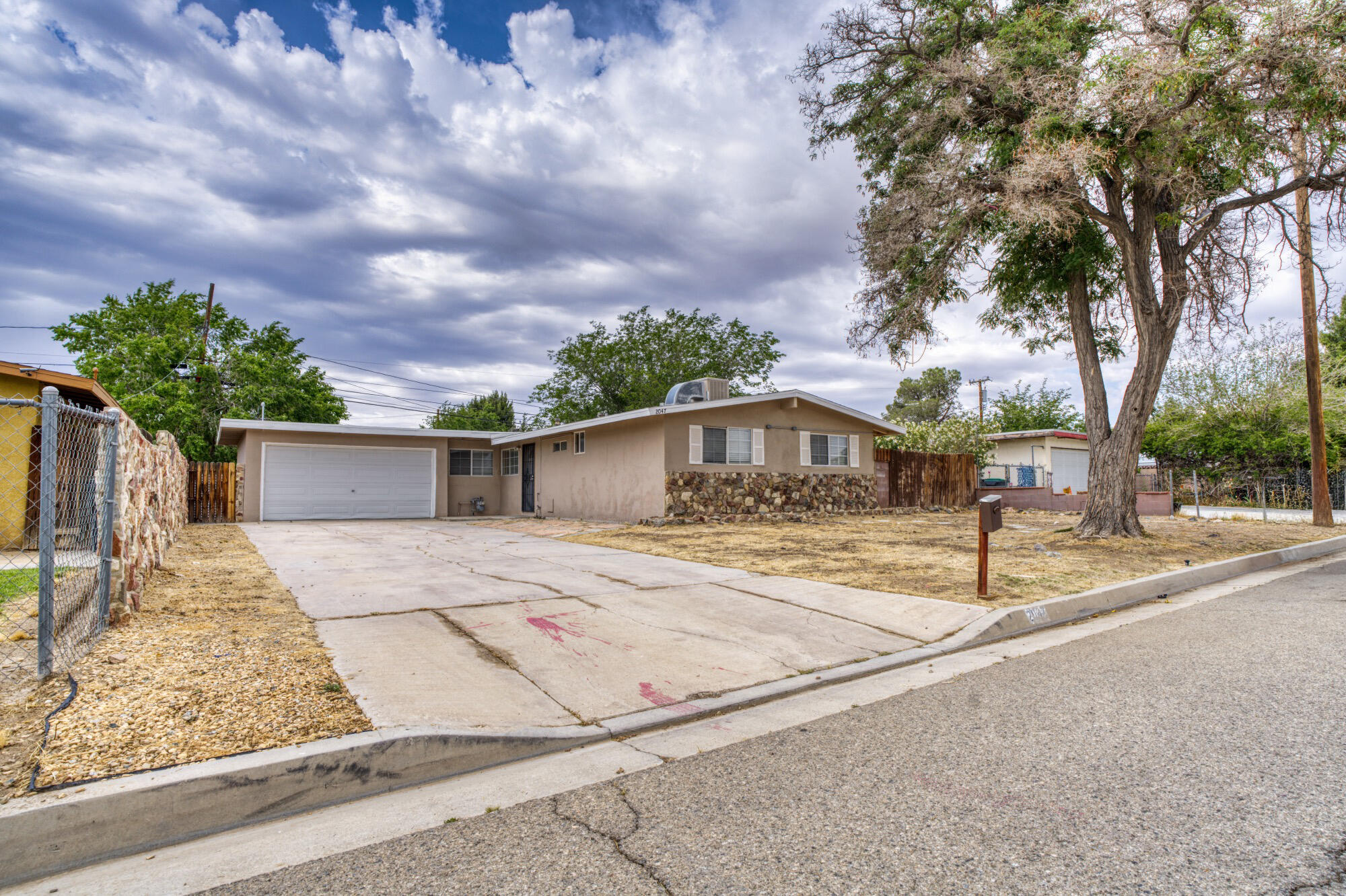 2047 West Lingard Street Lancaster, CA 93536 - Photo 13 of 15 a front view of a house with a yard and garage