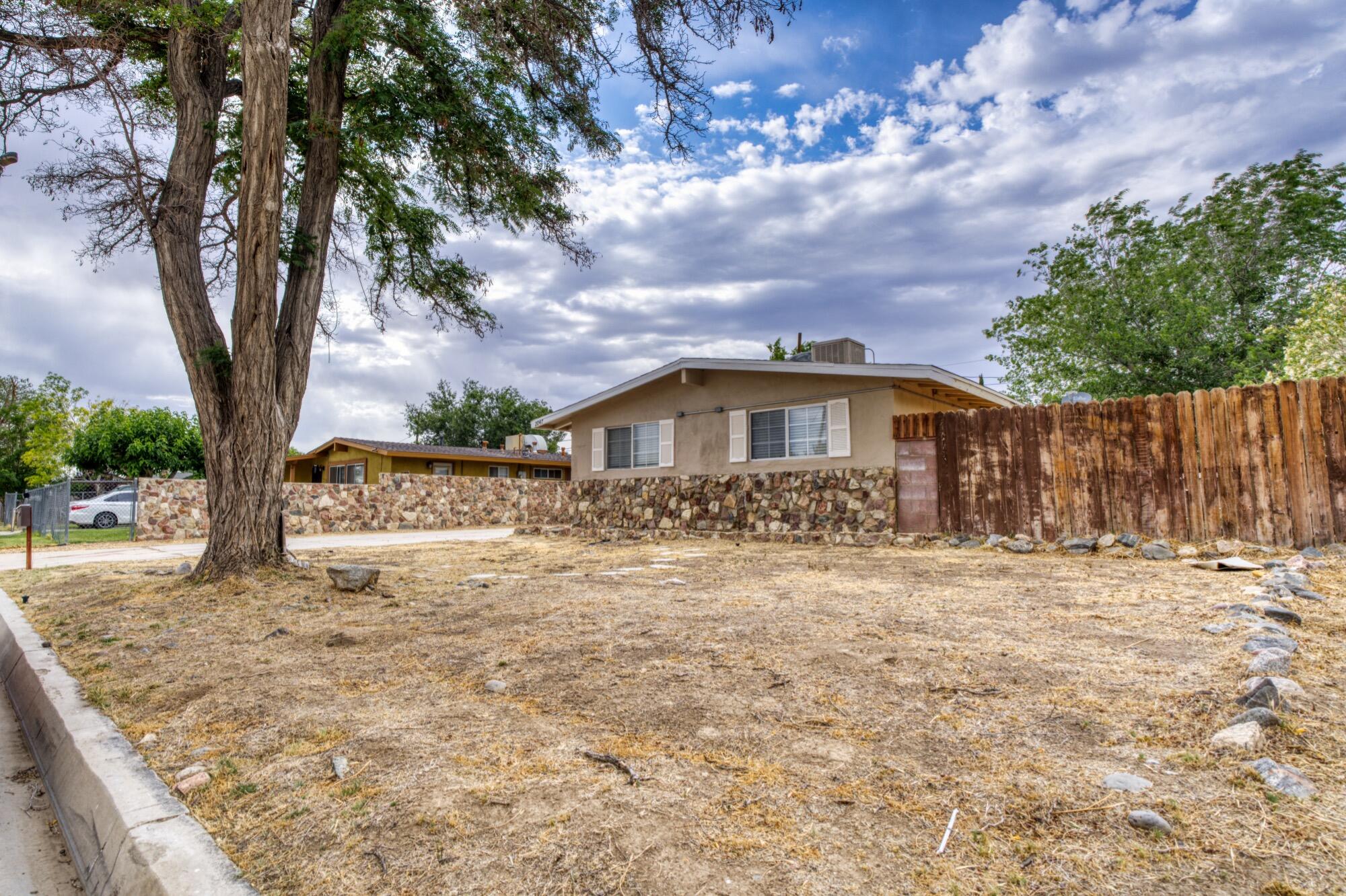 2047 West Lingard Street Lancaster, CA 93536 - Photo 15 of 15 a front view of house with yard and trees in the background