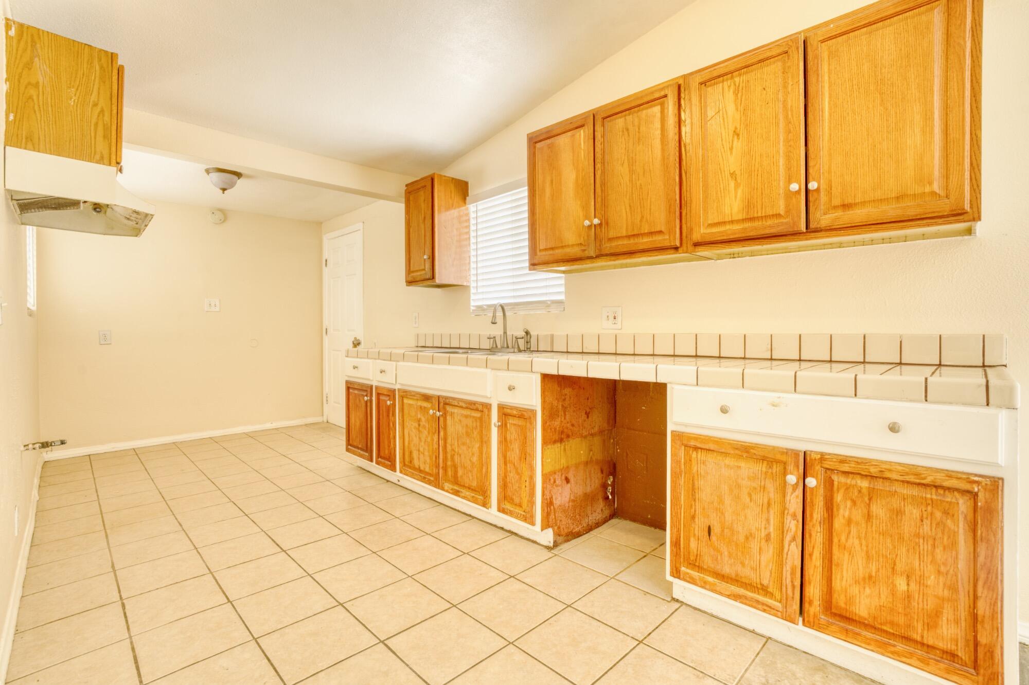 2047 West Lingard Street Lancaster, CA 93536 - Photo 7 of 15 a kitchen with stainless steel appliances granite countertop a sink and cabinets