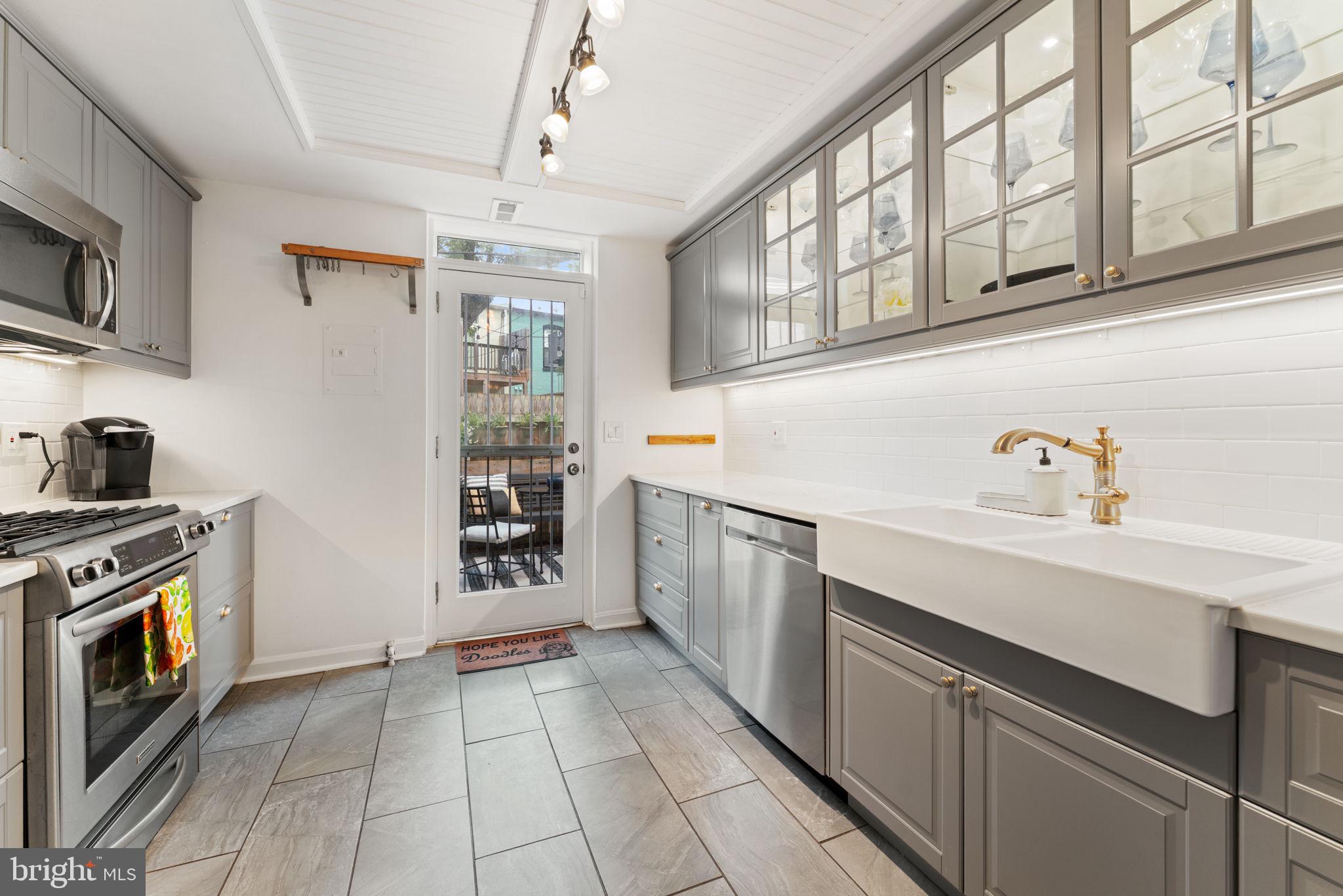 1314 C Street Southeast Washington, DC 20003 - Photo 10 of 30 a kitchen with stainless steel appliances granite countertop a stove and a sink