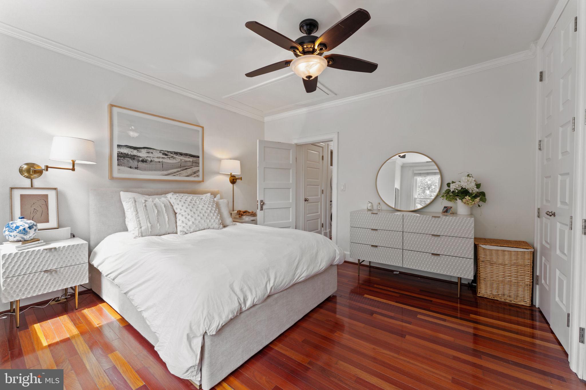 1314 C Street Southeast Washington, DC 20003 - Photo 18 of 30 a bedroom with a bed and a chandelier