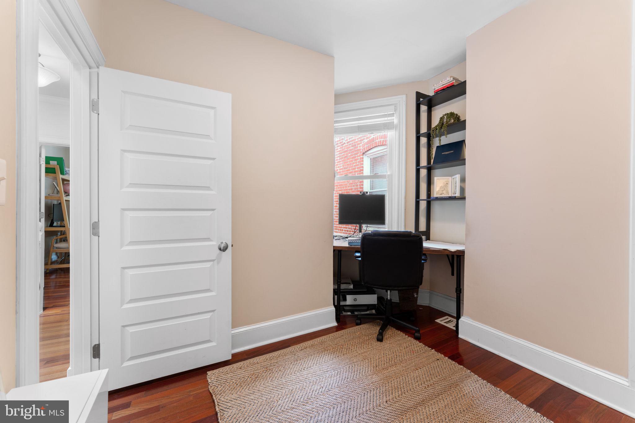 1314 C Street Southeast Washington, DC 20003 - Photo 20 of 30 a view of a workspace with furniture and a window