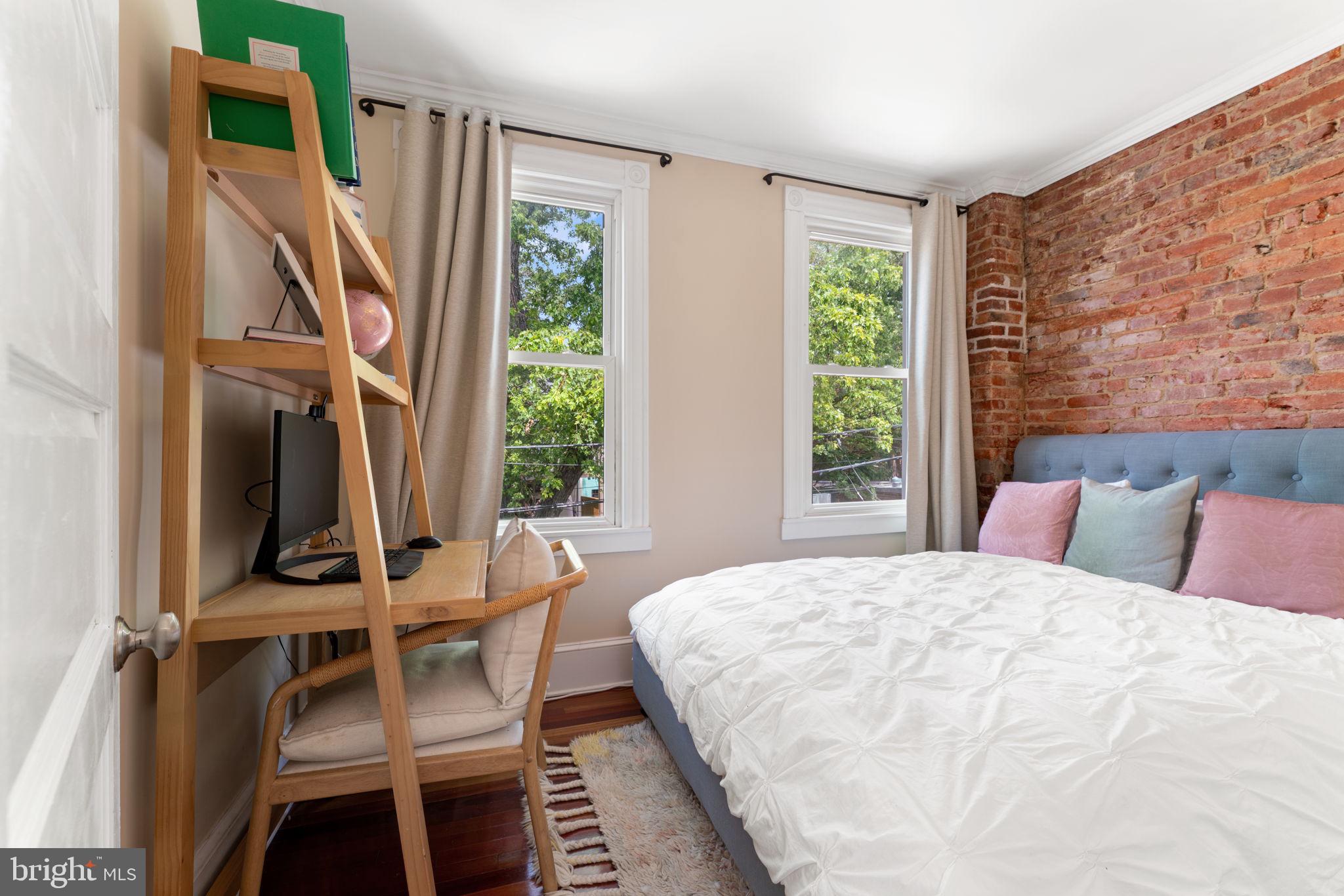 1314 C Street Southeast Washington, DC 20003 - Photo 22 of 30 a bedroom with a bed a flat screen tv and a large window with chair