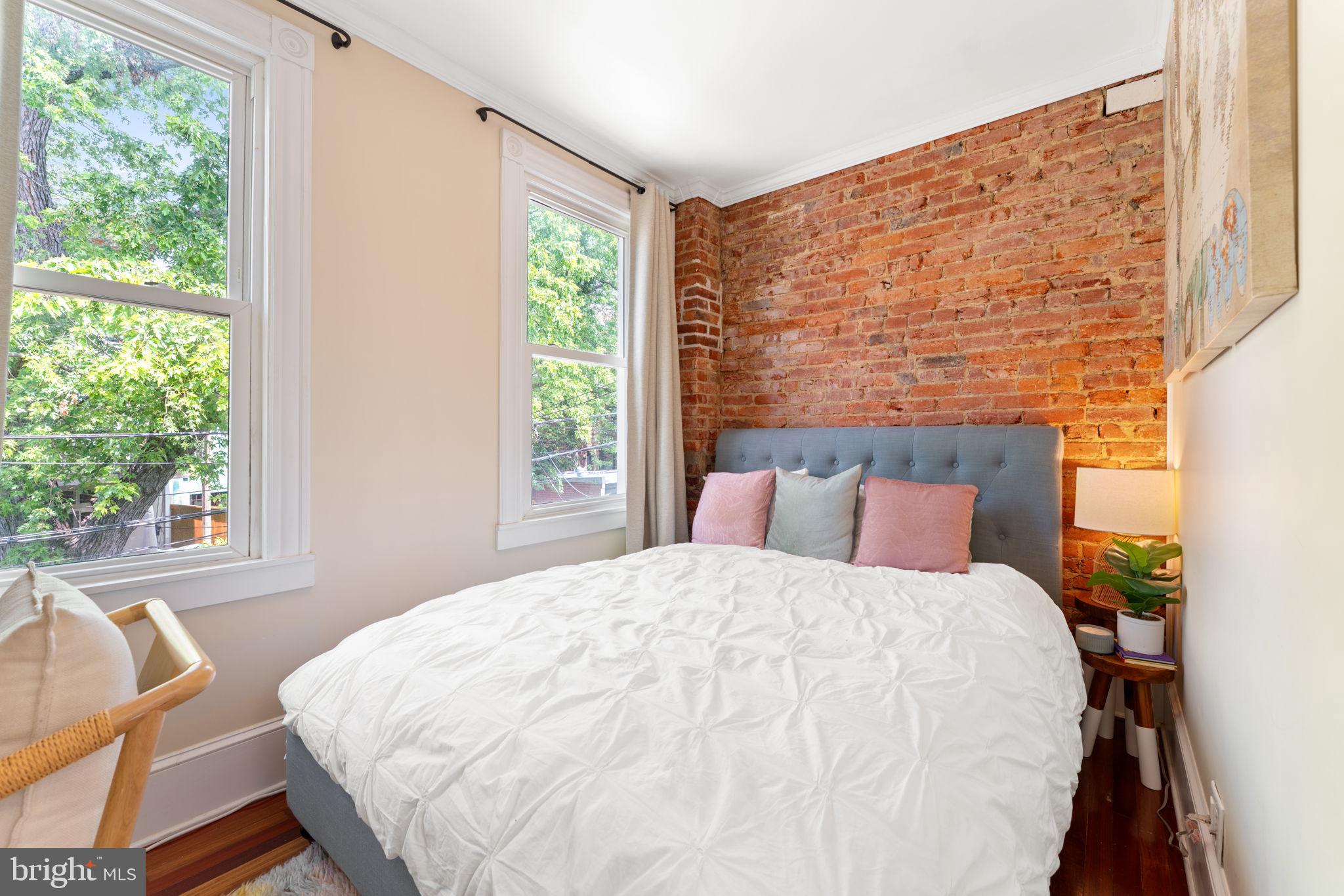 1314 C Street Southeast Washington, DC 20003 - Photo 23 of 30 a large white bed sitting in a bedroom next to a window