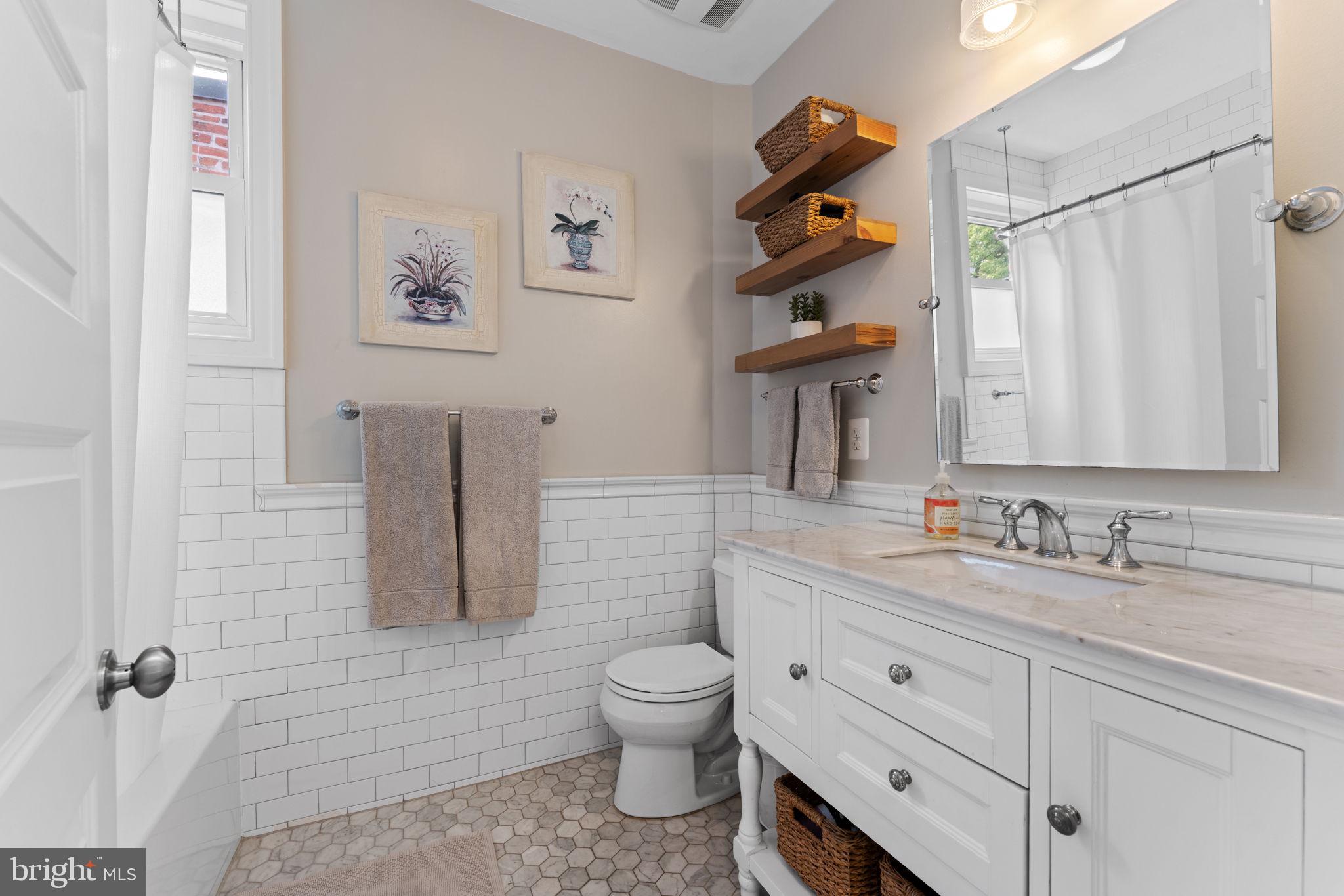 1314 C Street Southeast Washington, DC 20003 - Photo 24 of 30 a bathroom with a toilet sink and mirror