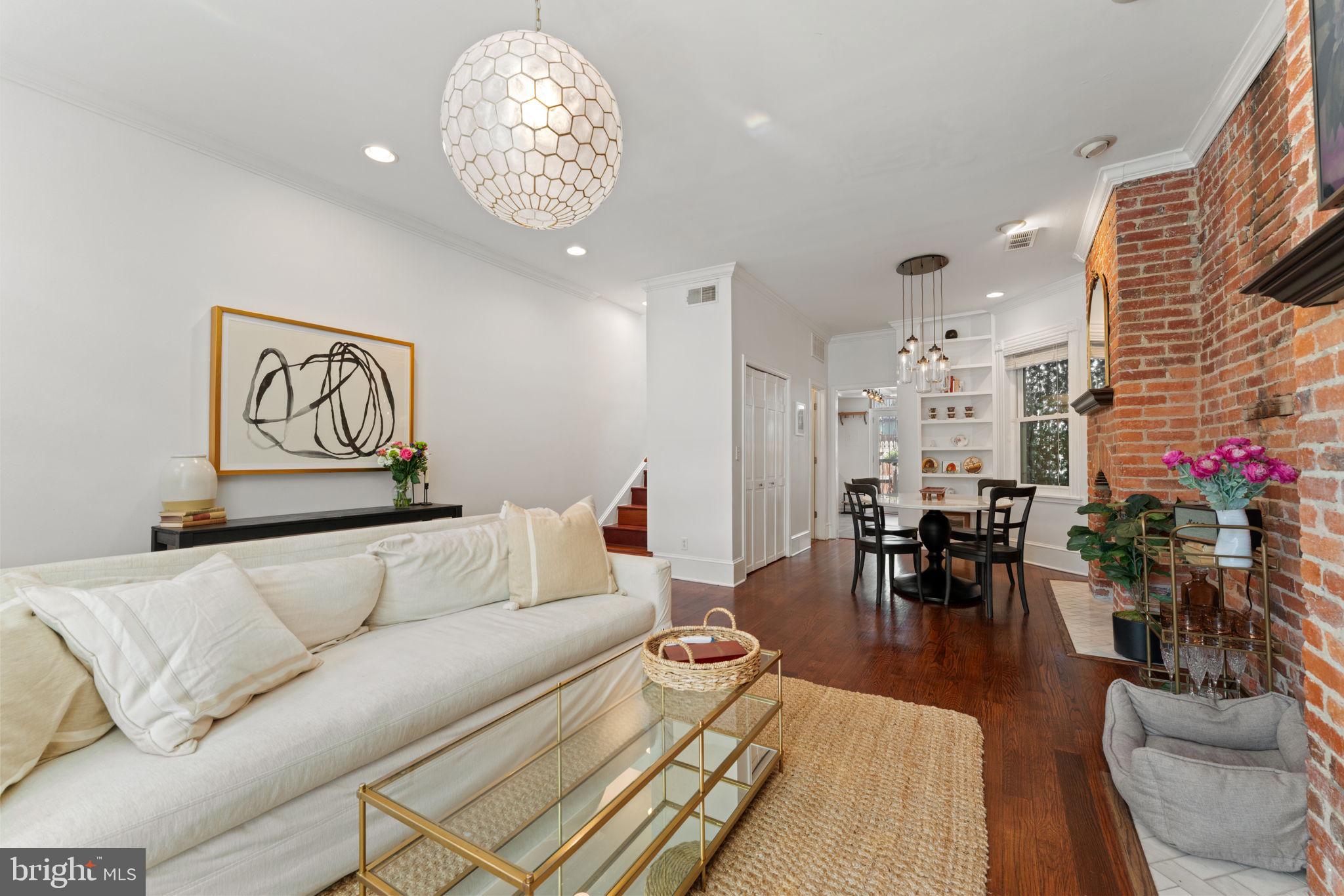 1314 C Street Southeast Washington, DC 20003 - Photo 3 of 30 a living room with furniture and a chandelier