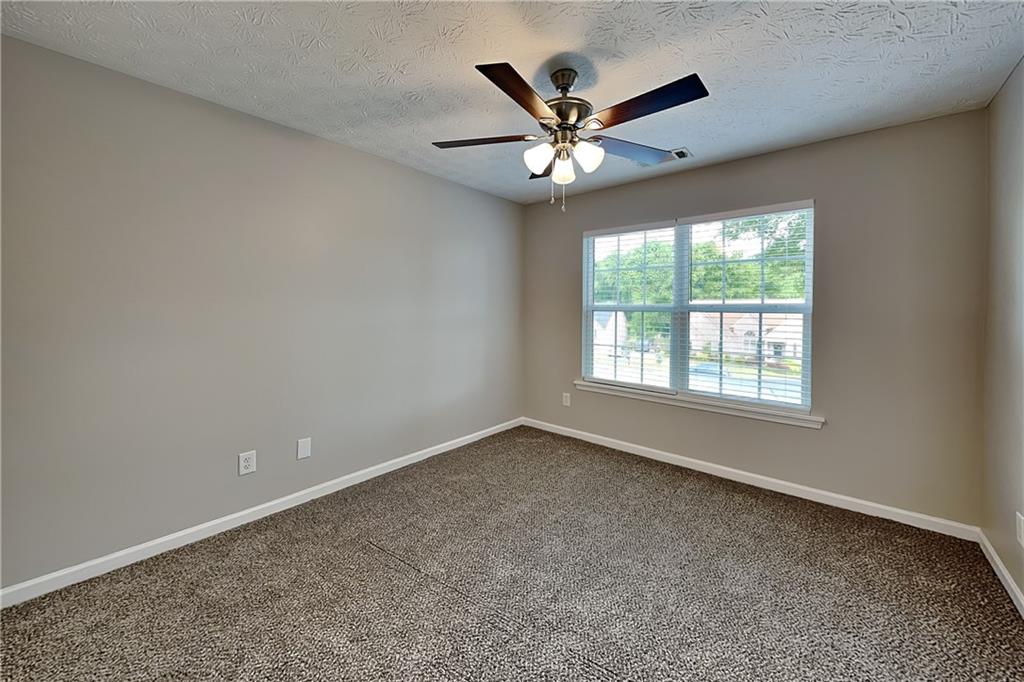 6345 Aarons Way Flowery Branch, GA 30542 - Photo 12 of 19 wooden floor in an empty room with a window