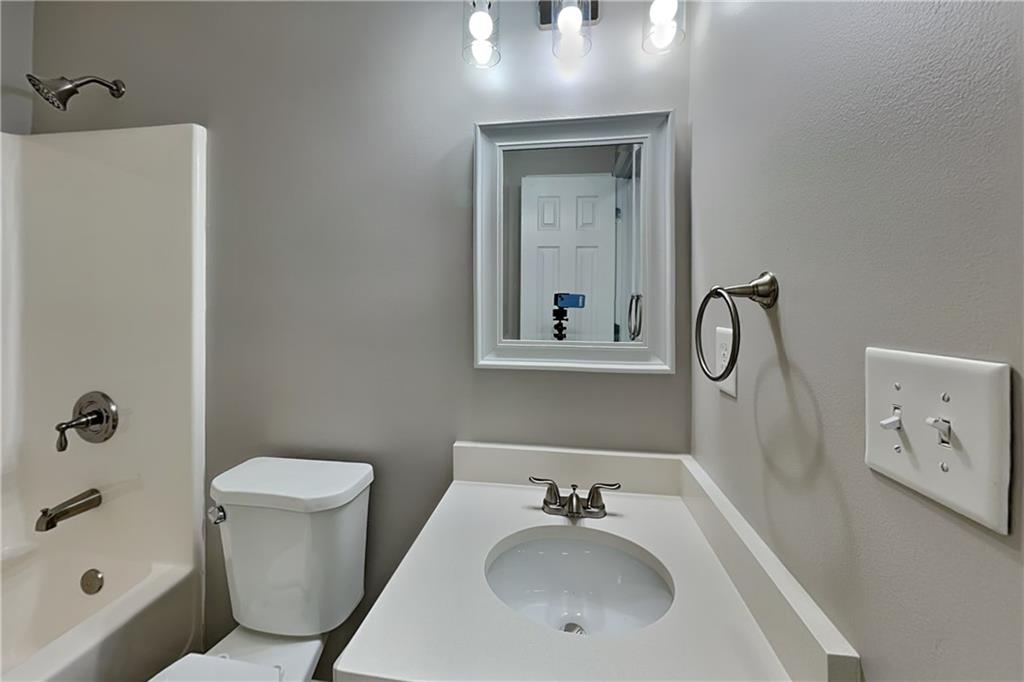 6345 Aarons Way Flowery Branch, GA 30542 - Photo 13 of 19 a bathroom with a sink toilet and shower