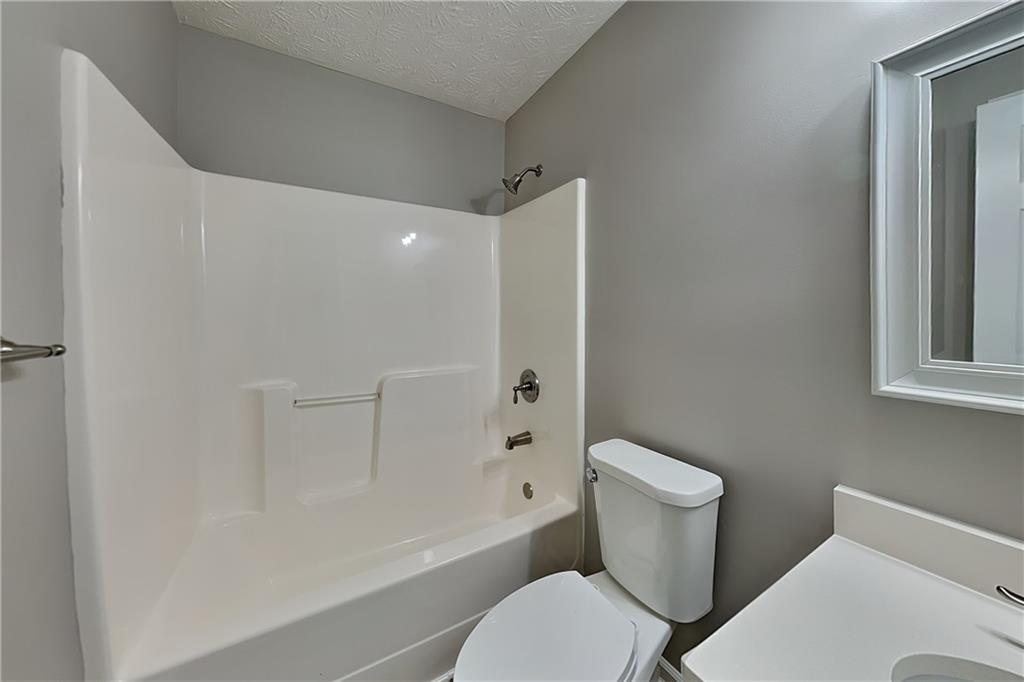 6345 Aarons Way Flowery Branch, GA 30542 - Photo 14 of 19 a white toilet sitting next to a bath tub shower