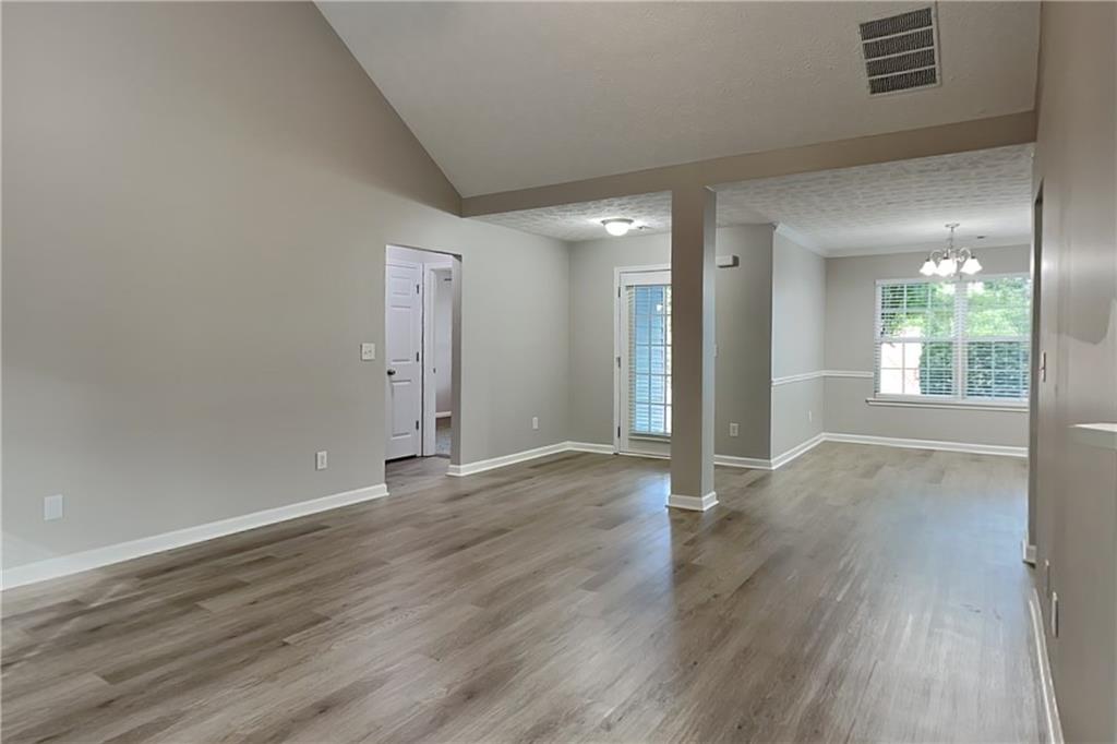 6345 Aarons Way Flowery Branch, GA 30542 - Photo 3 of 19 an empty room with wooden floor and windows