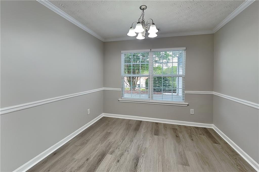 6345 Aarons Way Flowery Branch, GA 30542 - Photo 5 of 19 wooden floor in an empty room with a window