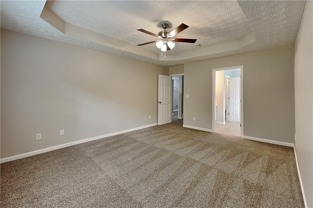 6345 Aarons Way Flowery Branch, GA 30542 - Photo 7 of 19 a view of an empty room with a ceiling fan