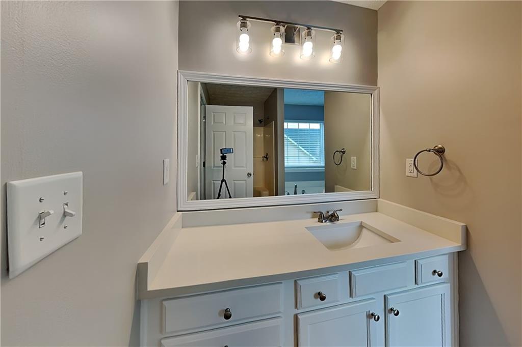 6345 Aarons Way Flowery Branch, GA 30542 - Photo 8 of 19 a bathroom with a sink and a mirror