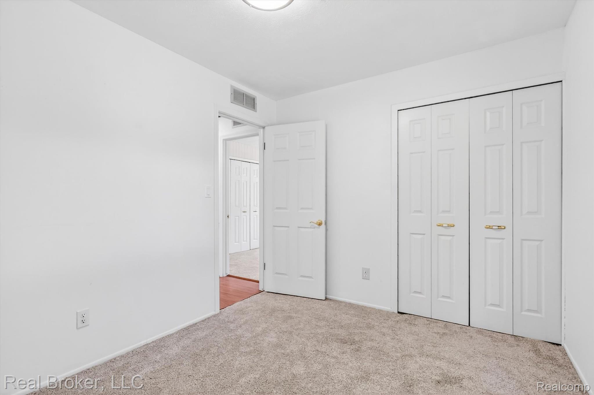 48050 Hull Road Belleville, MI 48111 - Photo 31 of 39 Carpeted room featuring white walls, a white ceiling, and a flush-mount ceiling light