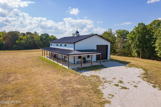 a view of a house with pool and chairs