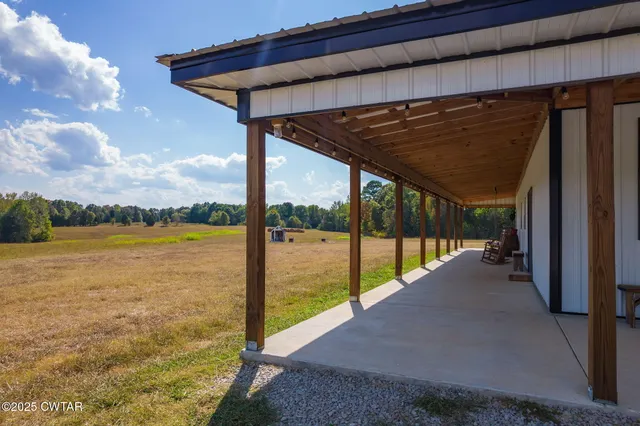 a white house that has a large pool in front of it