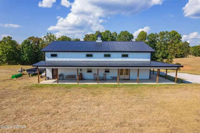 a view of a house with pool and chairs