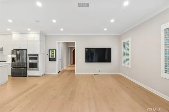 a view of a kitchen with a sink and a refrigerator