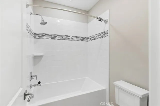 a bathroom with a shower and toilet