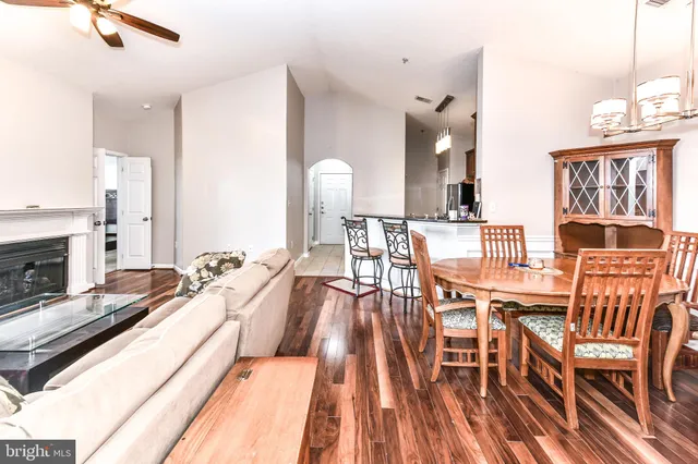 a view of a dining room with furniture a rug and wooden floor