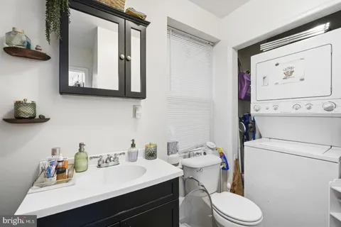 a bathroom with a toilet a sink and a mirror