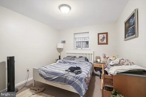 a bedroom that has a bed and a table in it