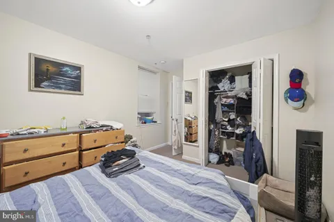 a bedroom with a bed and a closet