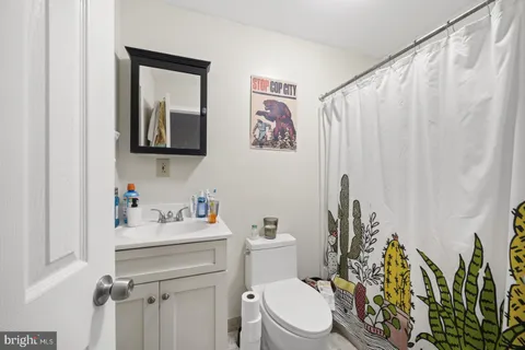 a bathroom with a toilet sink and vanity