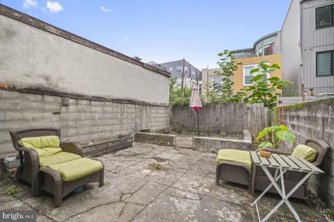 a backyard with a couch and some plants