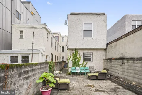 a front view of a house with outdoor seating