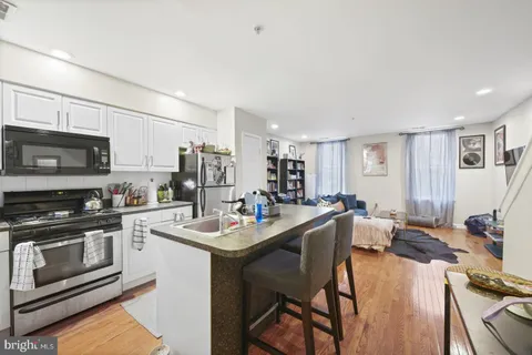 a kitchen with a sink stove and microwave