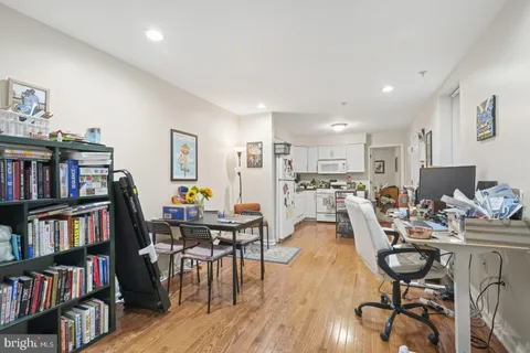 a living room with lots of furniture and a book shelf