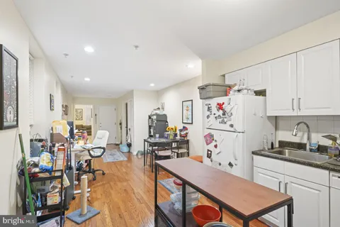 a kitchen with a refrigerator and a stove top oven