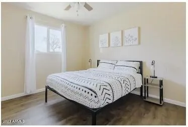 a bedroom with a bed two lamps and a table