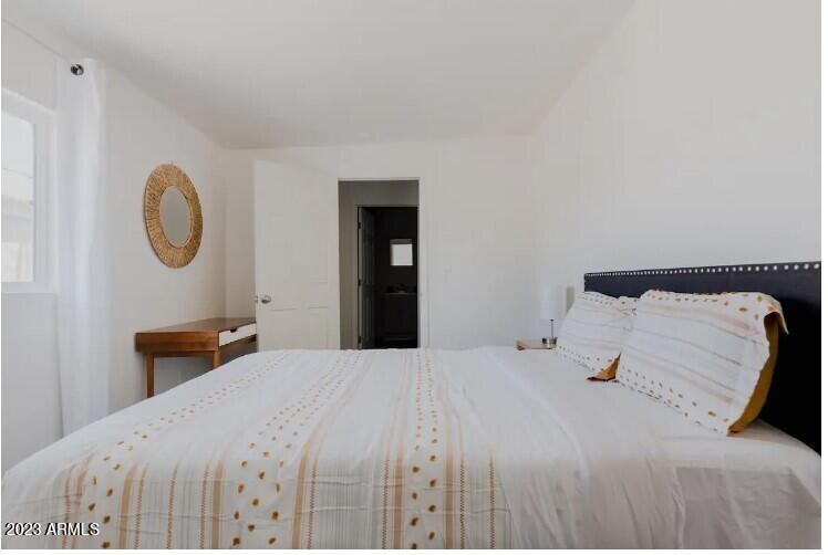 1048 West 12th Place Tempe, AZ 85281 - Photo 14 of 19 a bedroom with a bed and a chandelier