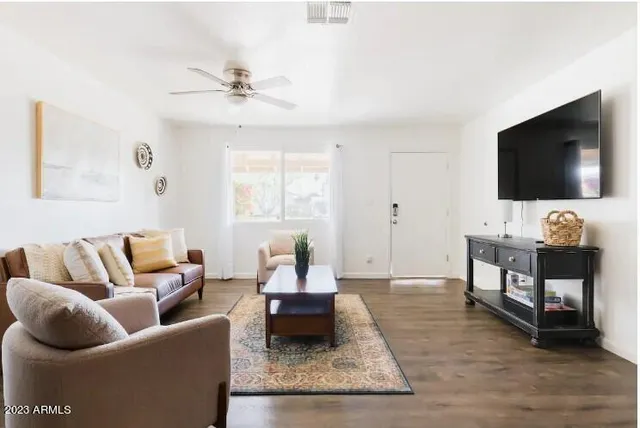 a living room with furniture and a flat screen tv