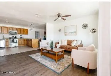 a living room with furniture and kitchen view