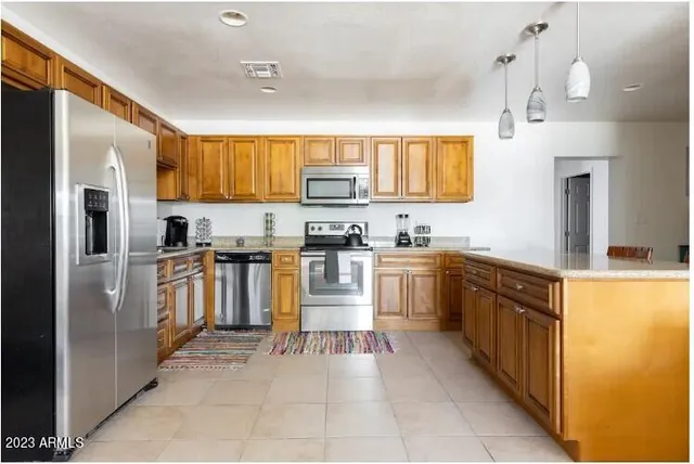 a kitchen with cabinets and stainless steel appliances