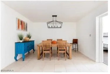 a dining room with furniture a chandelier and a rug