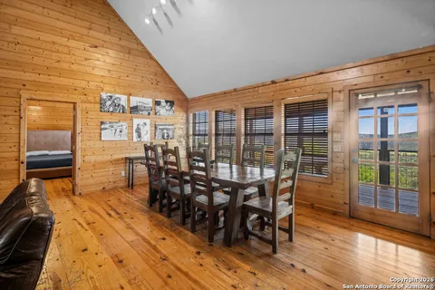 a dining room with furniture and wooden floor