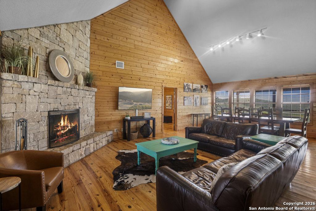 360 Bluebonnet Concan, TX 78838 - Photo 6 of 40 a living room with furniture a fireplace and a flat screen tv